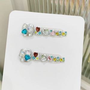 Silver press-on toenails with colorful rhinestones in heart and square shapes