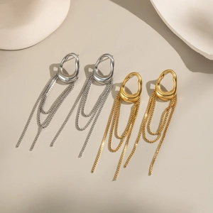 Detailed view of luxury gold and silver tassel earrings with irregular geometric rings