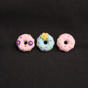 Cute cartoon resin donut brooches in pink and blue with 3D floral accents for apparel