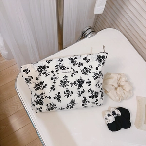 Detail view of retro floral cotton makeup bag with 'simple wish' label and accessories