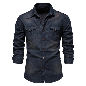 Detail of dark blue denim shirt with long sleeves, twin chest pockets and copper buttons