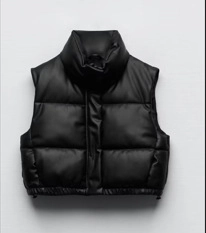 Close-up of black matte faux leather padded vest showing stand collar and quilted texture