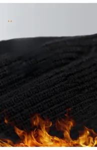 Detail of black vertical ribbed knit fabric with thermal properties and soft texture
