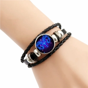 Luminous Aries zodiac multilayer leather bracelet with glowing blue glass gemstone on wrist