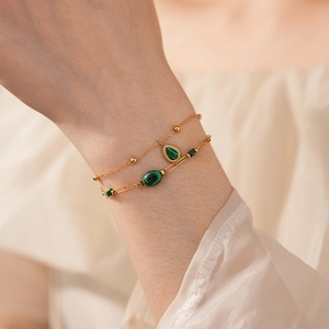 Détail du bracelet chaîne vintage plaqué or avec pendentif en malachite verte au poignet