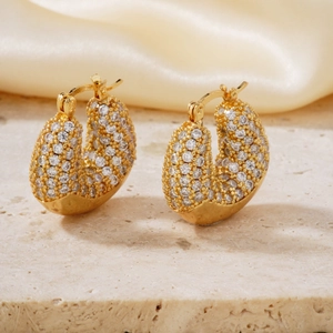 Vintage style gold earrings with sparkling pave zircon stones in a classic hoop design