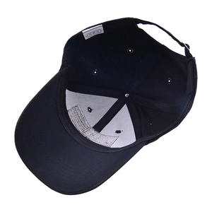 Interior detail of black cotton baseball cap showing reinforced lining and wash label