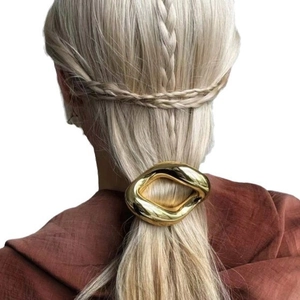 Elegant gold irregular oval hair clip shown on model for a minimalist aesthetic