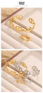 Detailed tile display of vintage gold and silver pig nose link bracelets and open rings