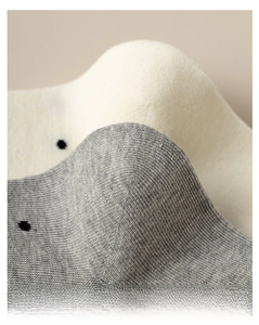 Detail shot of reinforced heel and knit texture on grey polka dot cotton socks