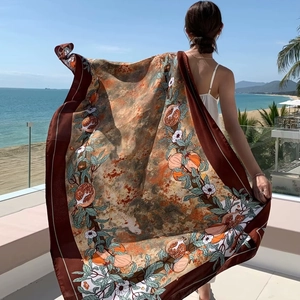 Ethnic pomegranate print sun protection shawl fluttering in the sea breeze at a beach resort