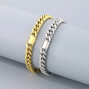 Polished gold and silver Cuban link chain bracelets with square clasp on display stand