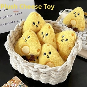 Macro detail of plush cheese-shaped pendants with cute cartoon faces in a white basket