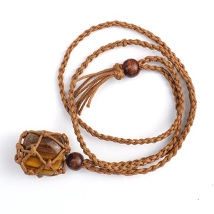 Detailed close-up of tiger eye stone pendant with brown handmade woven net and wooden beads