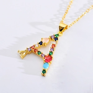 Detail of a golden letter A necklace pendant with sparkling colorful zircon stones