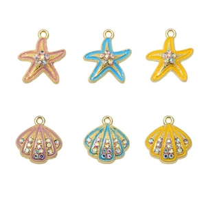 Starfish and shell jewelry charms with enamel finish and crystal accents on white base