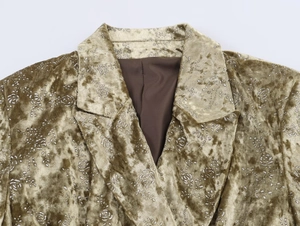 Detail of velvet blazer featuring intricate silver rose floral embroidery and lapel