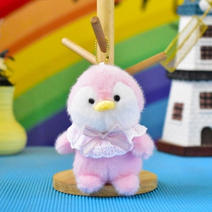 Close-up of a cute pink penguin plush keychain featuring a delicate white lace collar