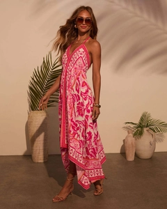 Detailed view of bohemian floral maxi dress with halter neckline and irregular flowy hemline
