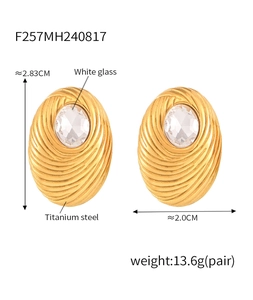 Detail view of gold plated oval earrings with white glass inlay and size measurements