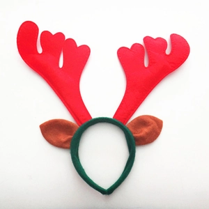 Detail of Christmas reindeer headband with red antlers, brown ears and green fabric
