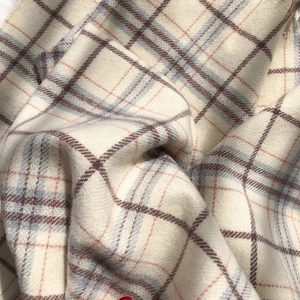Nahaufnahme des weichen karierten Schals in Beige und Blau mit Kaschmir-Gefühl Textur