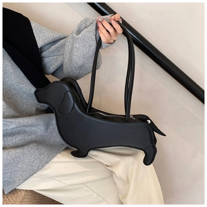 Detail of creative dachshund shaped shoulder bag in black leather with metal zipper