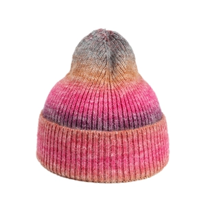 Detailed view of the gradient rib-knit texture and folded cuff on the colorful beanie