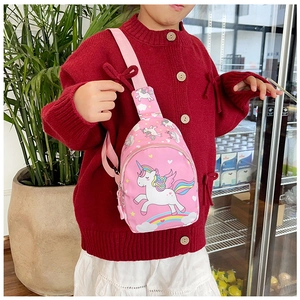 Girl wearing a pink unicorn chest bag with adjustable strap in a lifestyle setting