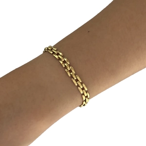 Luxe gold stainless steel triple-link bracelet with zircon inlay on female wrist