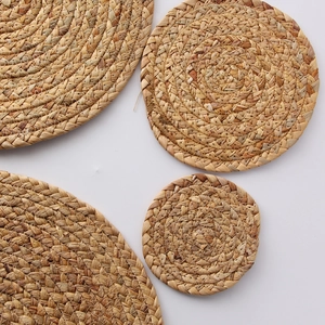 Handcrafted round water hyacinth placemats in four sizes for natural table protection