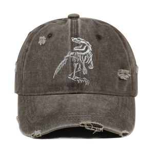 Vintage washed black baseball cap with distressed holes and dinosaur skeleton embroidery