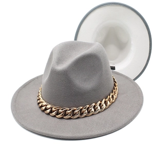 Detail view of grey wool fedora hat with chunky gold acrylic chain on white background