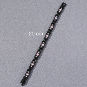 Detail of 20 cm black magnetic link bracelet with pink stones and clear crystals