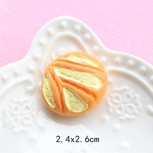 Detailed view of resin miniature bread accessory with orange and yellow stripes 2.4x2.6cm