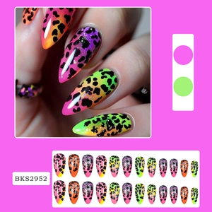 Detailed view of neon leopard print long fake nails with pink and orange gradients
