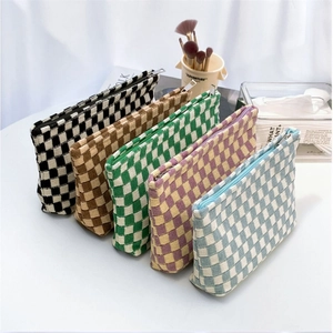 Collection of checkered knit pouches in five colorways for makeup or stationery storage