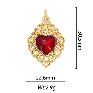 Detail view of heart pendant with red gemstone and dimensions 30.5mm by 22.6mm