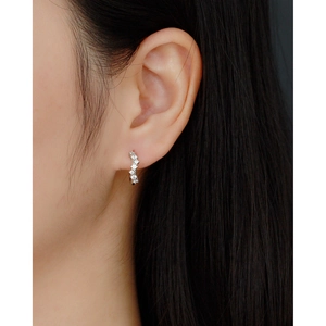 Close-up of S925 silver wavy geometric hoop earrings with diamonds on a model