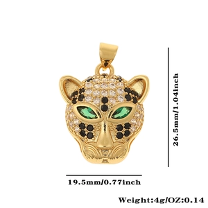 Macro shot of gold leopard pendant with zircon and green gemstone eyes showing dimensions