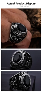 Macro detail of gothic stainless steel ring featuring black gemstone and Eye of Providence