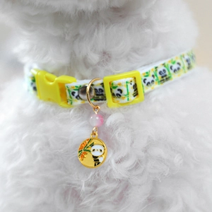 Detail of adjustable panda print pet collar with yellow buckle and golden panda charm