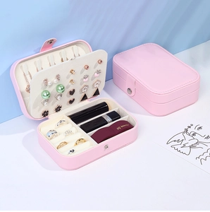 Pink PU leather jewelry box showing earring plates, necklace hooks and ring slots