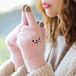 Detail of pink knitted touchscreen gloves with cute cartoon embroidery and cozy fit