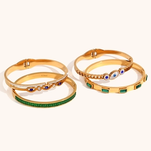 Golden stainless steel bracelets set with Evil Eye charms and green gemstones
