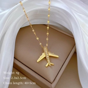 Macro detail of gold airplane pendant with pave crystals and precise size measurements