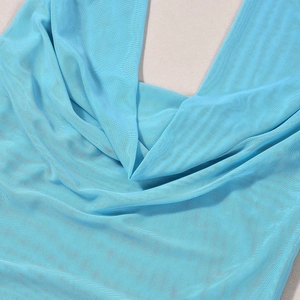 Close-up of blue mesh fabric texture showing detailed net structure of the two-piece set