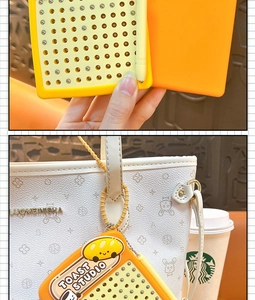 Detail view of the square magnetic bead keychain showing its hanging effect on a bag