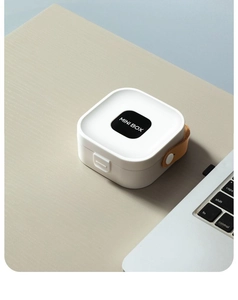 Mini white portable storage box with brown leather handle on a minimalist desk