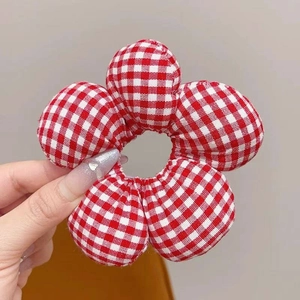 Detail of a large red and white gingham floral scrunchie with 3D padded flower petals